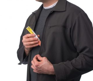 Person carrying a detachable Dispill dose cup